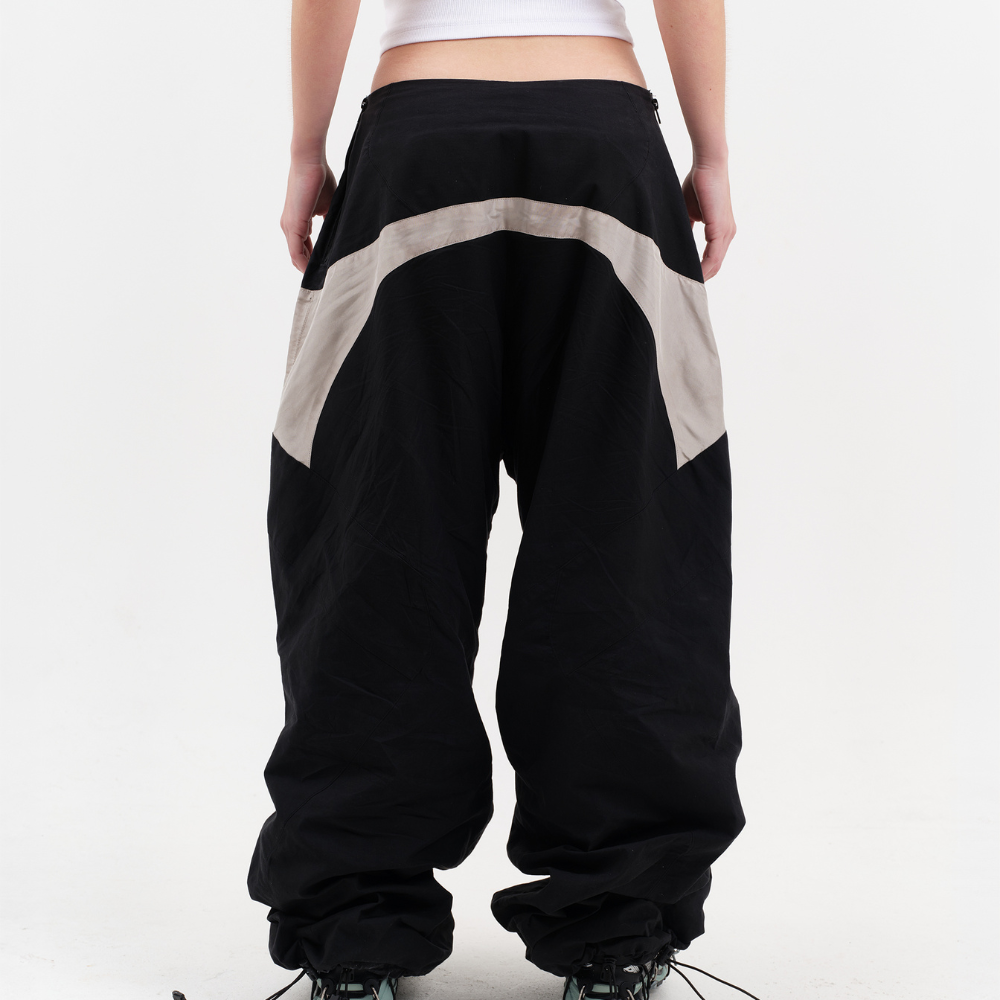 Shop online from our exclusive website and discover the Dimension Track Pants by Voitech®, featuring technical nylon, reflective panels, adjustable bungee hems, and a modular futuristic streetwear design.