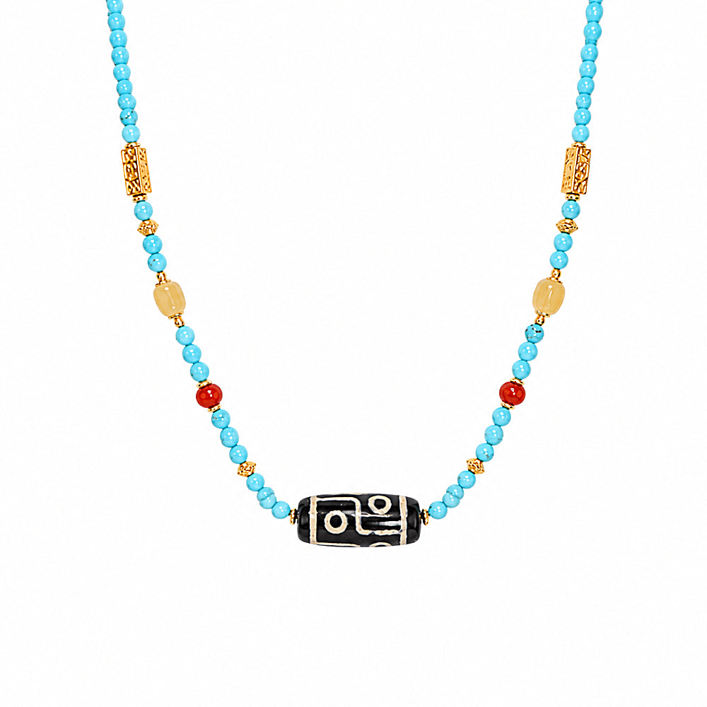 Discover the Dolma Turquoise & Dzi Bead Necklace at The Luxe Maison, featuring agate Dzi beads, turquoise, carnelian, and amber in a timeless design.