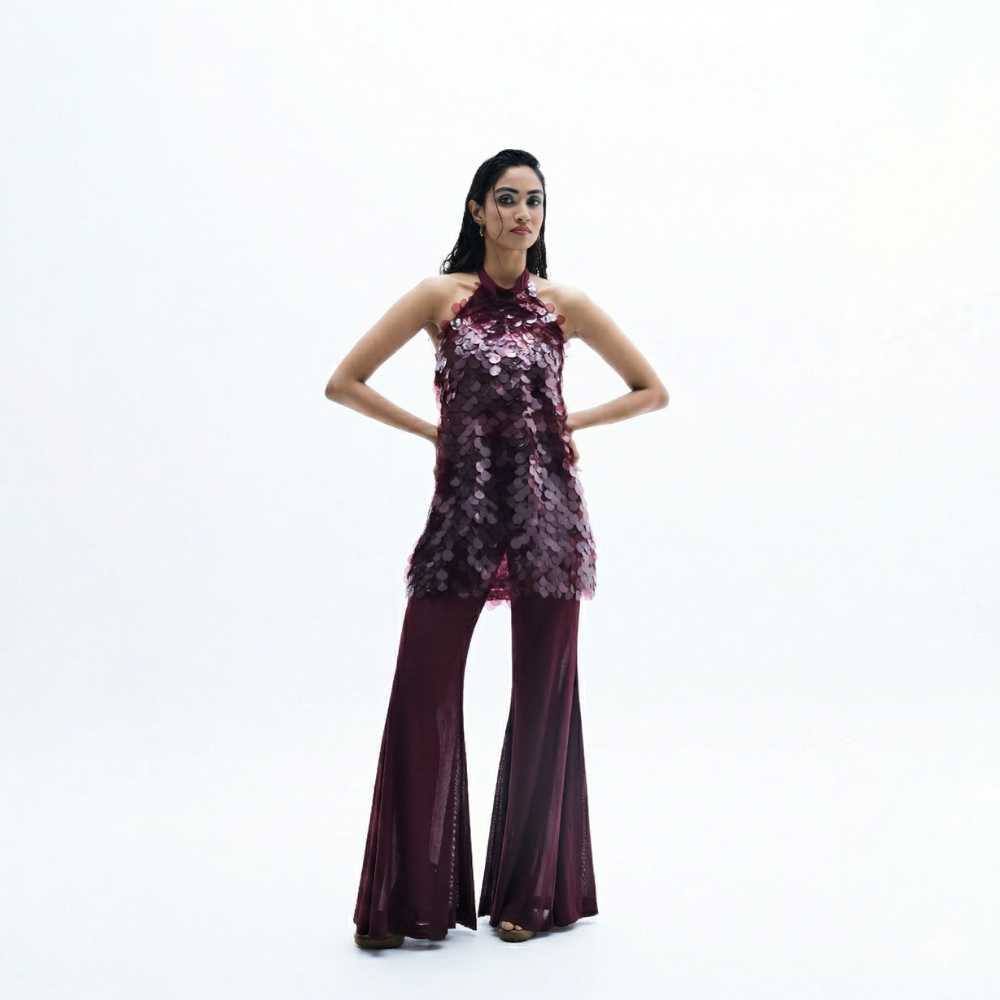 Sequin halter top with flared pants and water sequin detail, perfect for vacations. Shop online from our exclusive collection of premium styles.