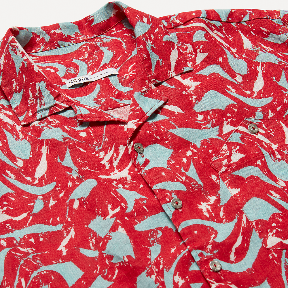 Lightweight bright red, ice blue, and optical white printed 100% linen long-sleeve shirt with a boxy fit. 