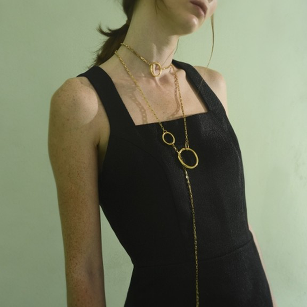 Long thin chain necklace with several different size rings.