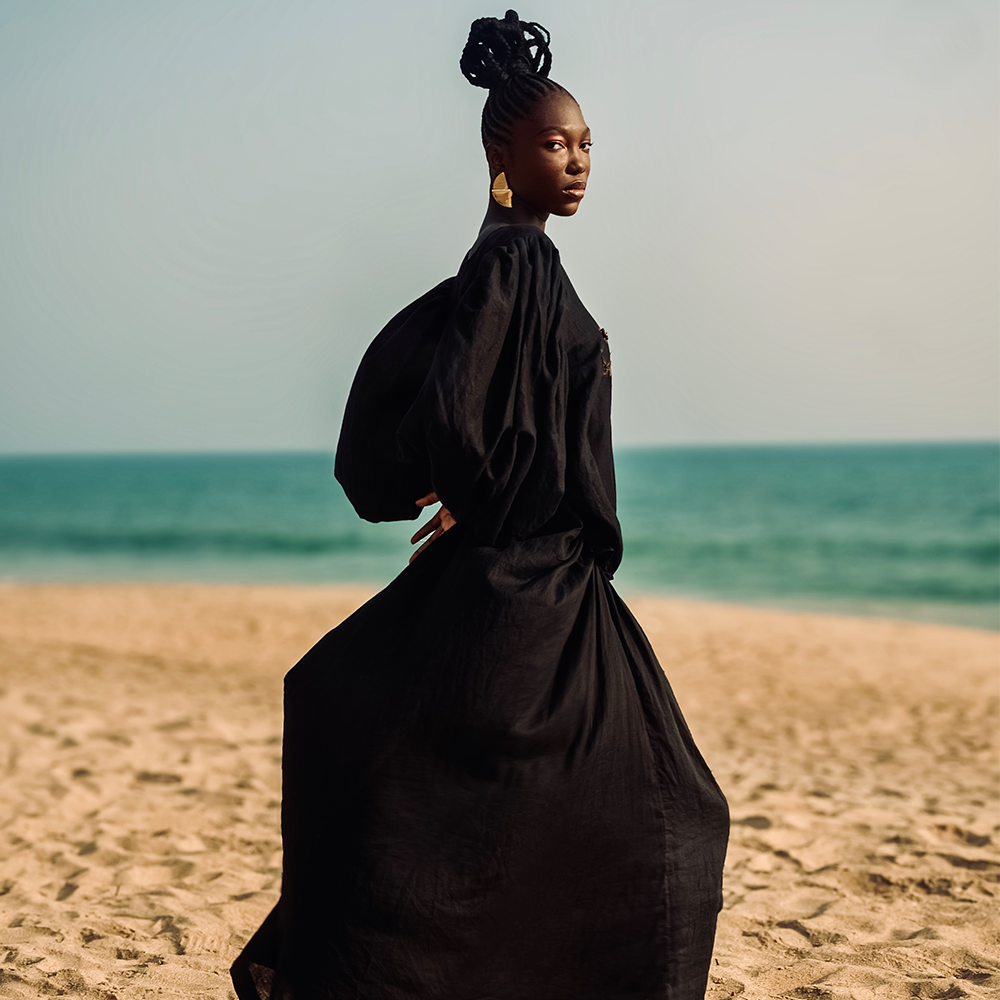 A draped dress with a ruched Bell sleeve, featuring reverse dyeing highlights and hand-beaded details 