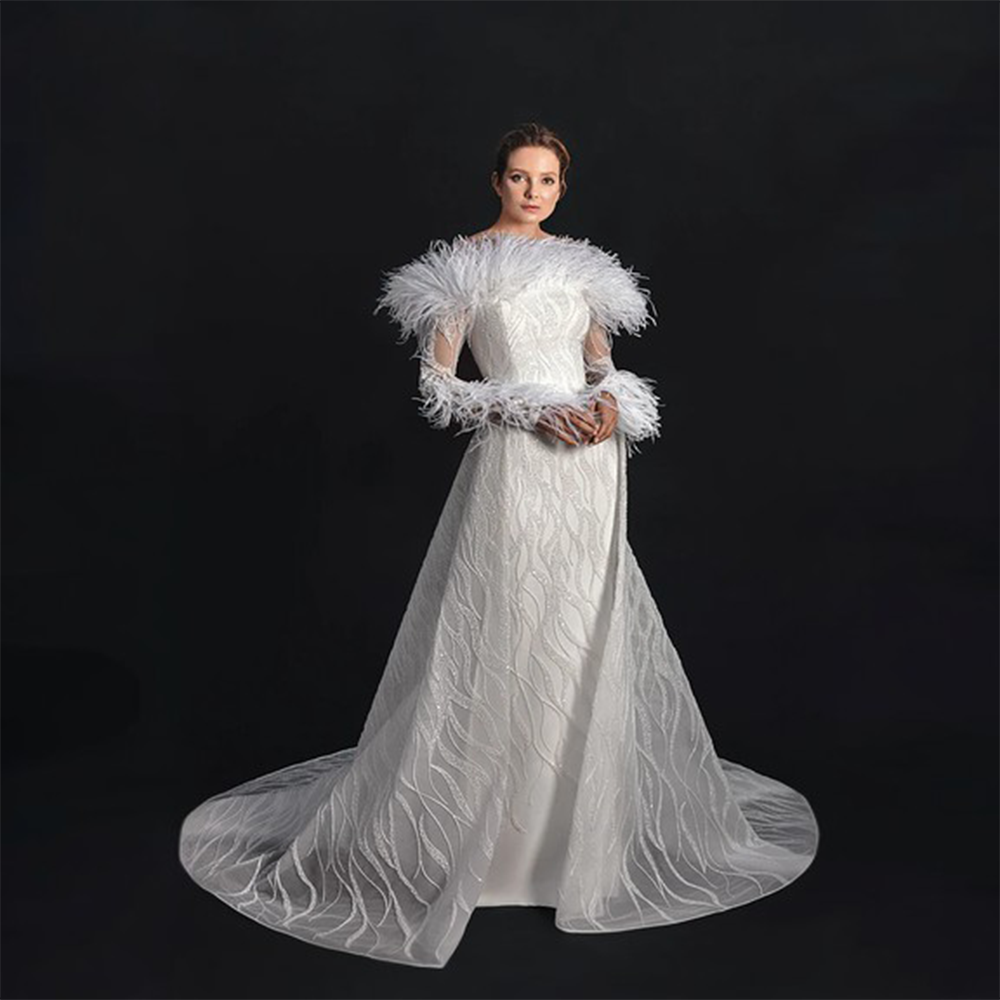 Fully embroidered bridal gown feautring ostrich feathers.