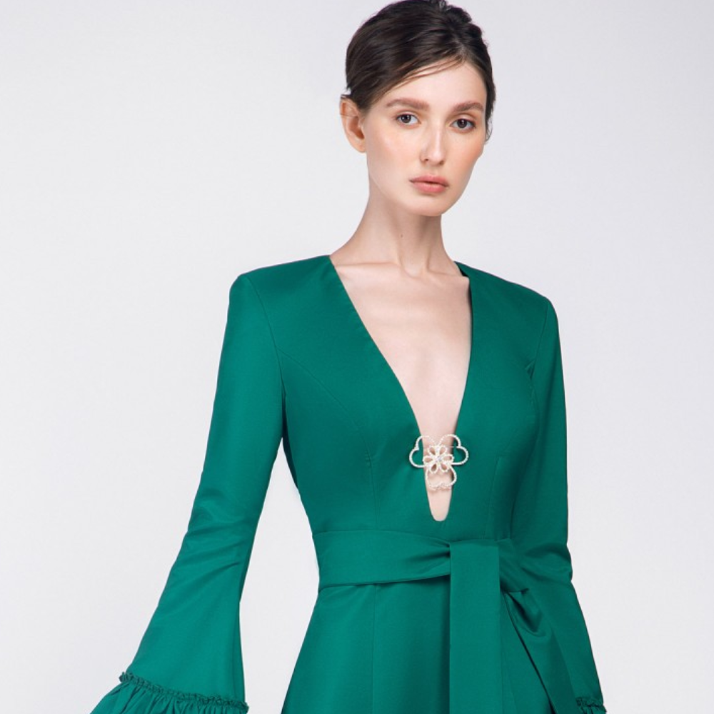 This emerald green full sleeves, short dress is perfect party wear. It has ruffles on the sleeves and the skirt.