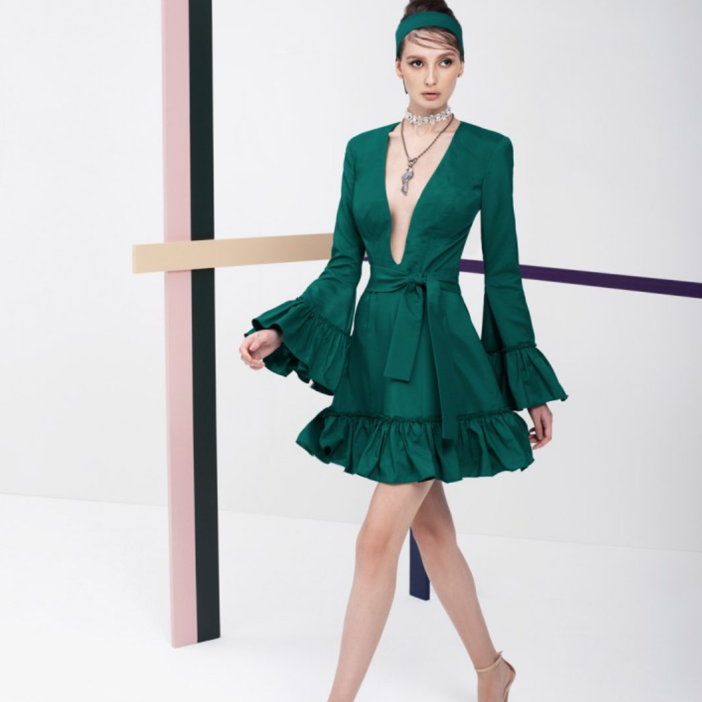 This emerald green full sleeves, short dress is perfect party wear. It has ruffles on the sleeves and the skirt.