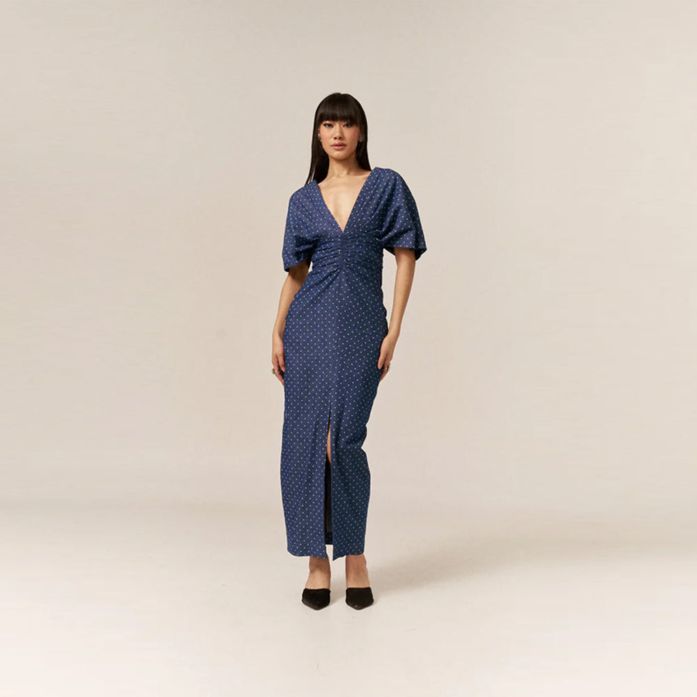 Polka dot denim dress with twisted front & slit hem waist-accentuating, perfect for brunch, birthdays, baby showers & garden parties.
