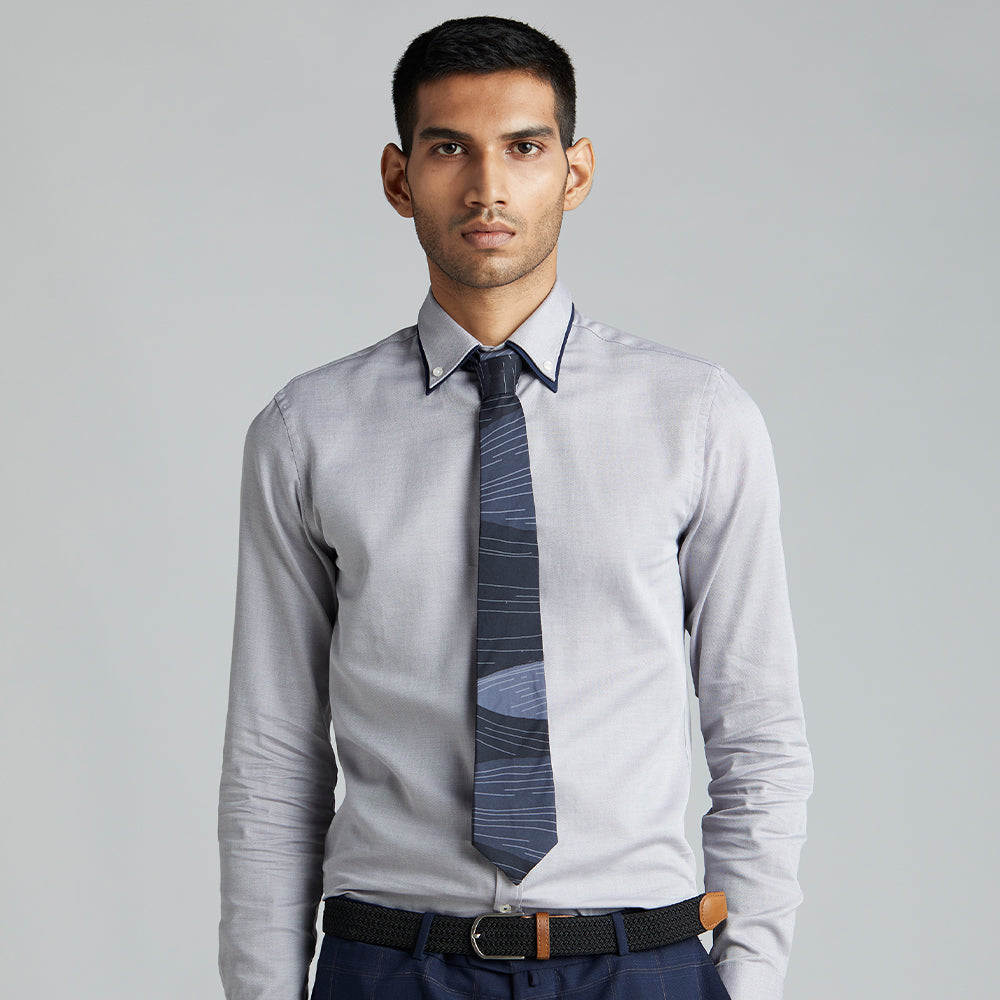A unique shaded navy tie with abstract white lines representing the star studded twilight sky.