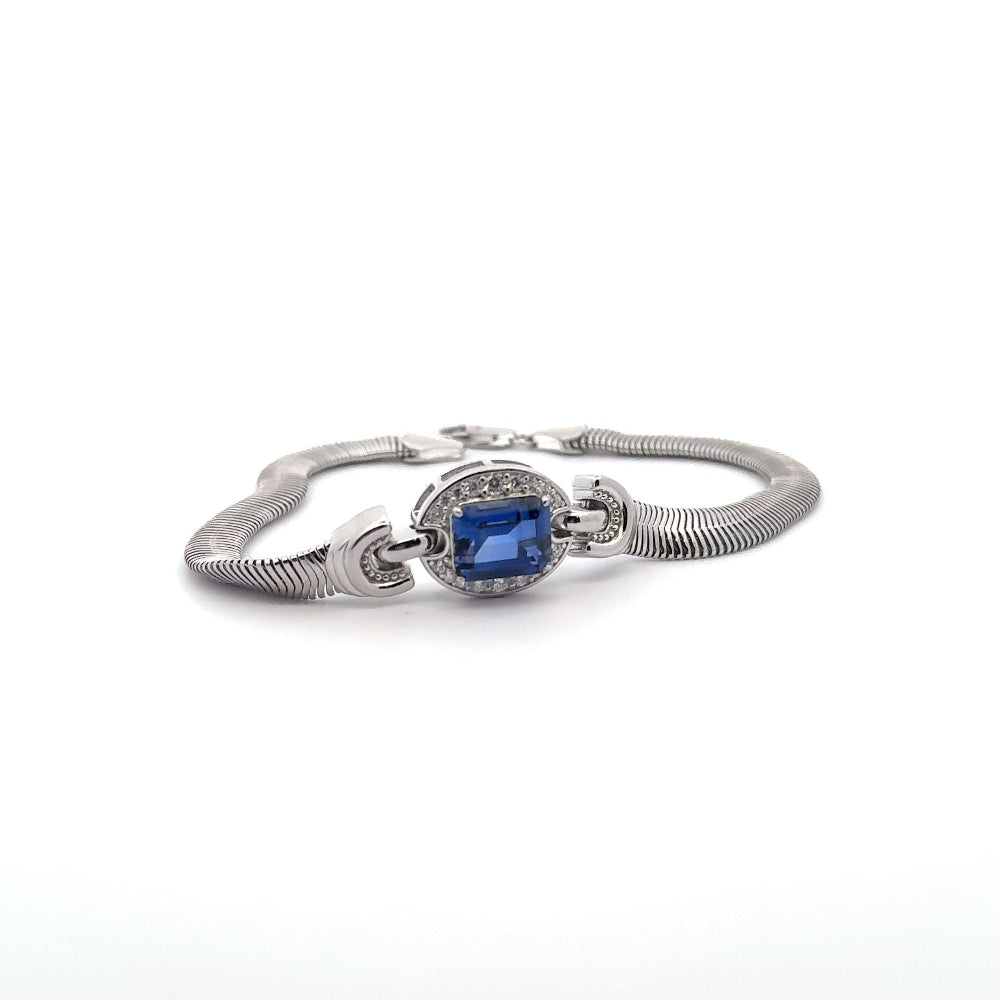 Sterling silver bracelet featuring a square emerald-cut lab-created blue sapphire center stone framed with sparkling cubic zirconia accents. Shop premium jewelry online.