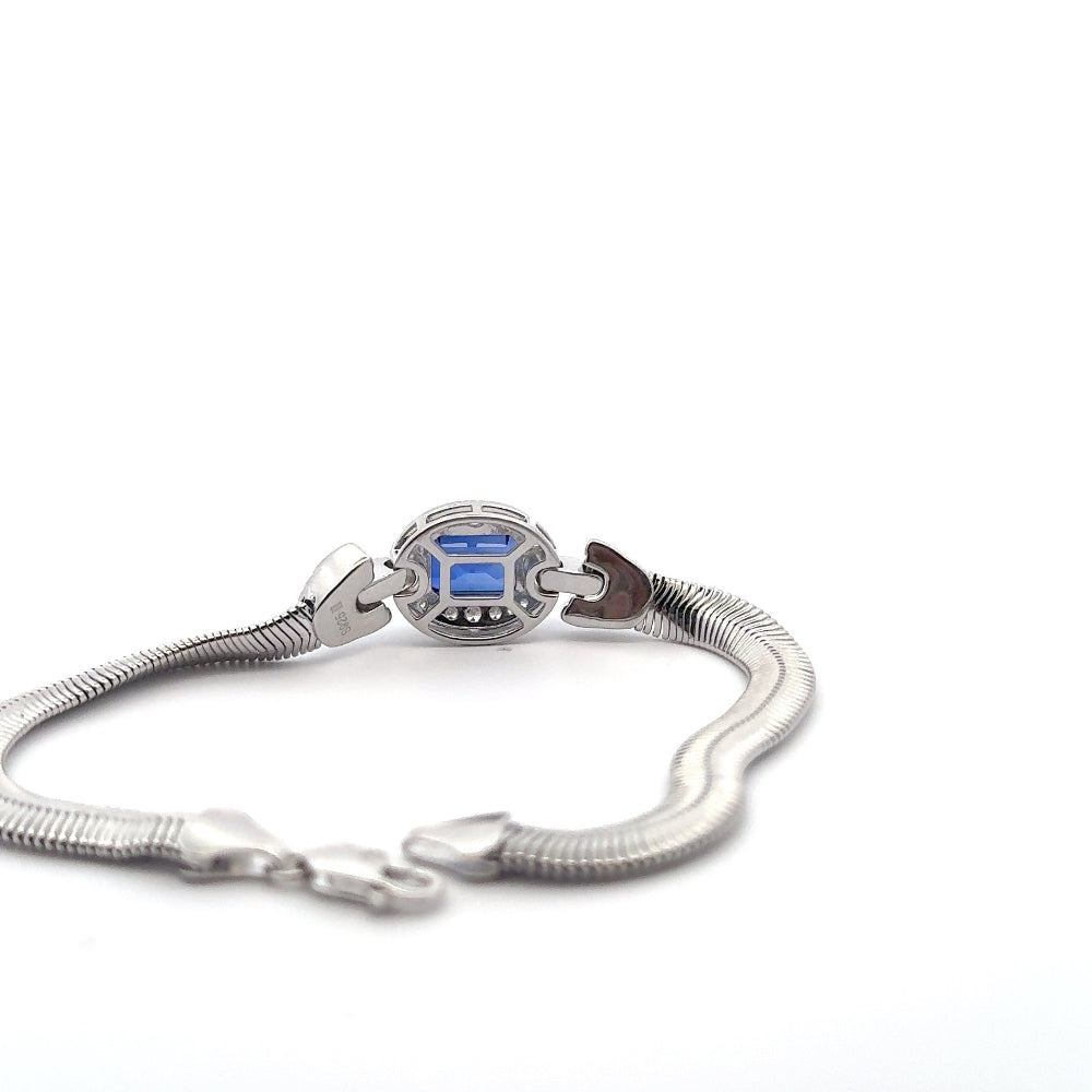 Sterling silver bracelet featuring a square emerald-cut lab-created blue sapphire center stone framed with sparkling cubic zirconia accents. Shop premium jewelry online.