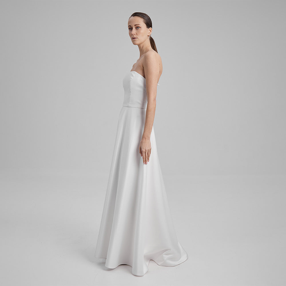 White Maxi Eve dress made from Mikado fabric and a corseted straight neckline exuding timeless elegance. Explore evening dresses for women. Shop now!