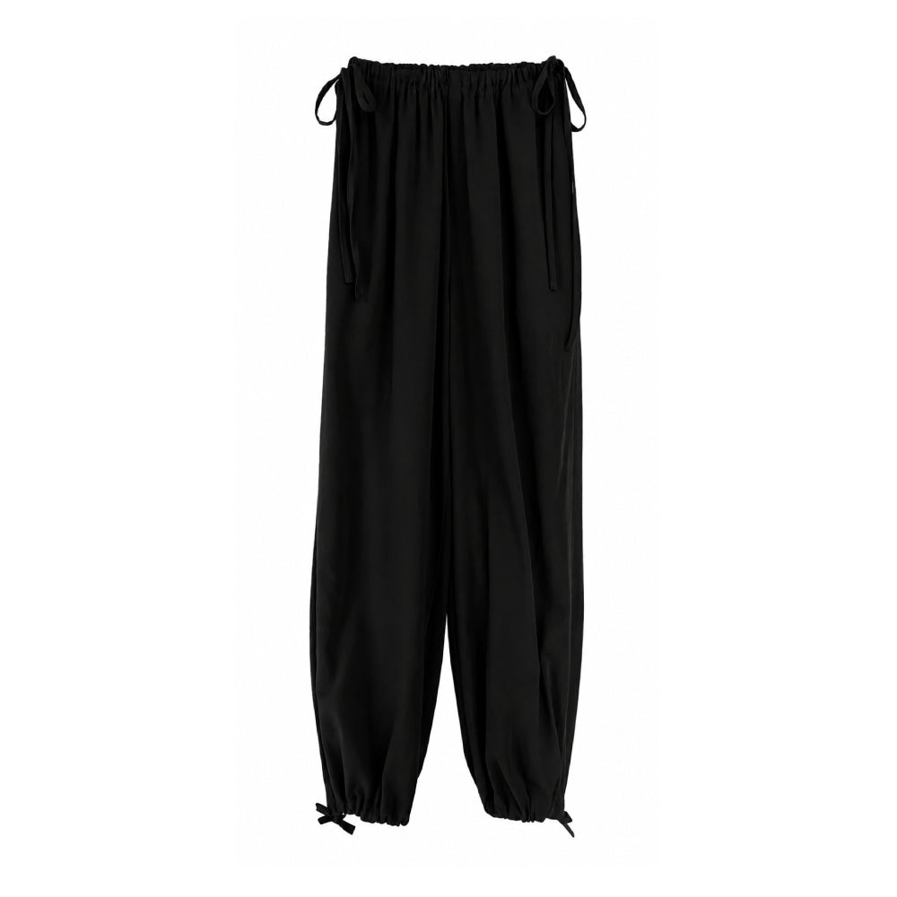 Discover the Faye Trousers at The Luxe Maison, featuring a relaxed wide-leg fit, ankle-length cut, drawstring waist with long ties, and side pockets.