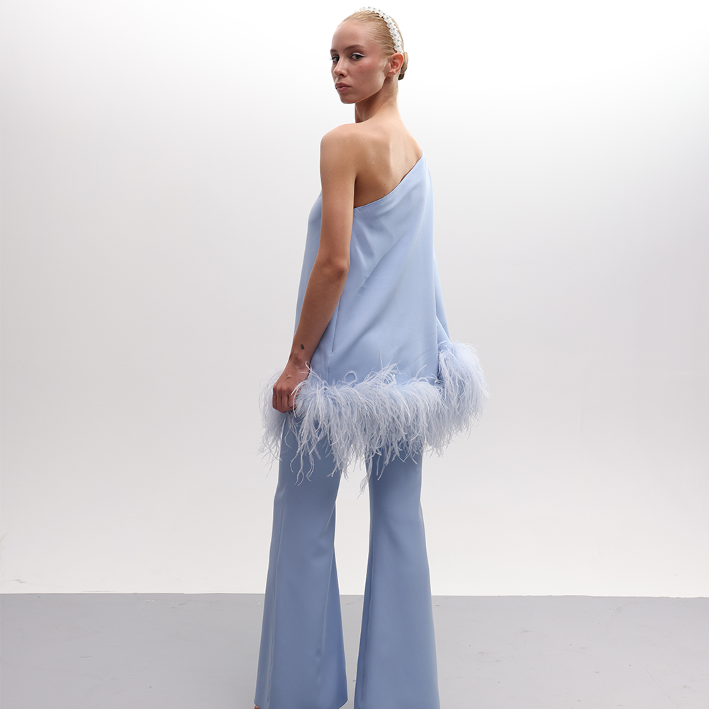 Introducing a chic one-shoulder baby blue top, featuring a sizable matching fabric flower and feather detailing.