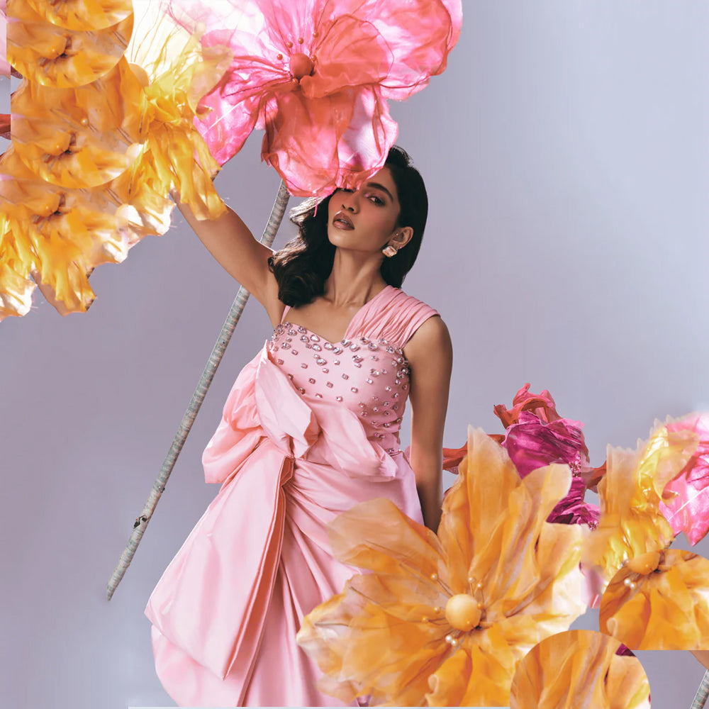 Pink gown with rhinestone bodice, ruched fit, and draped skirt, perfect for weddings. Shop online from our exclusive collection of premium styles.