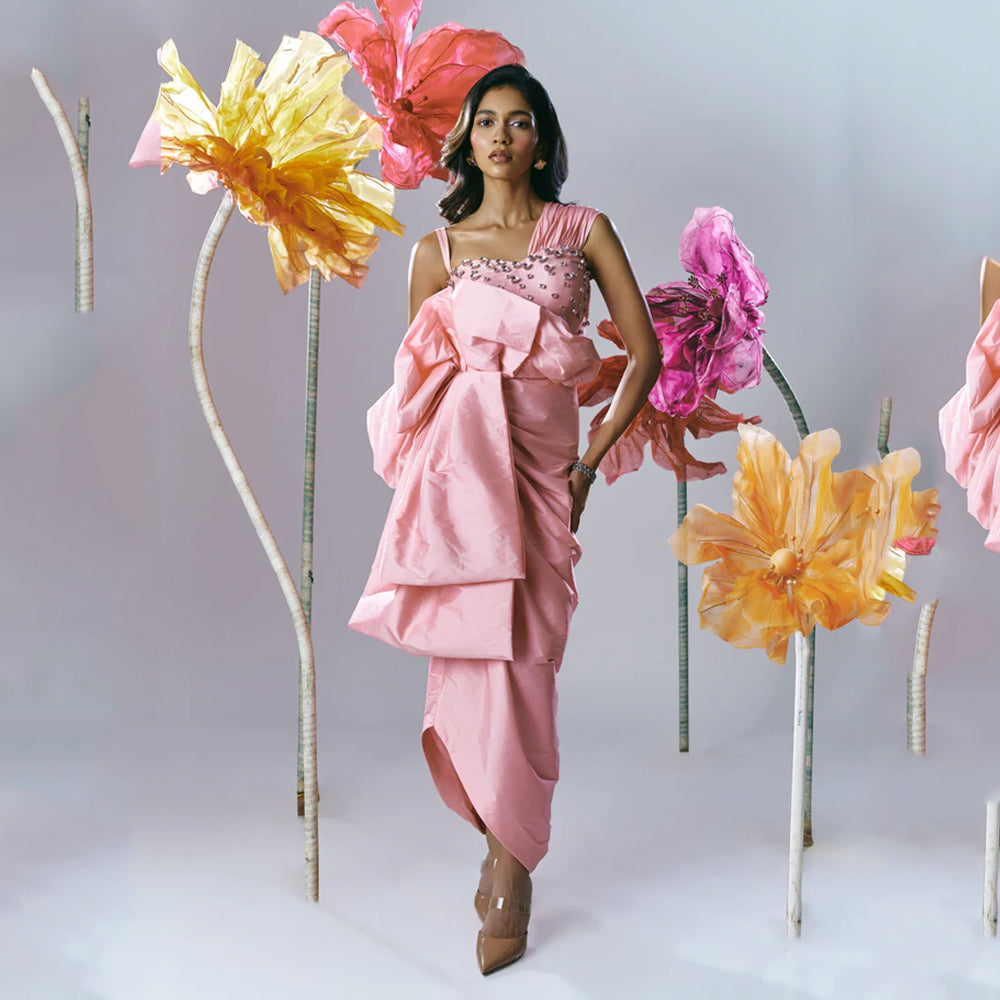 Pink gown with rhinestone bodice, ruched fit, and draped skirt, perfect for weddings. Shop online from our exclusive collection of premium styles.