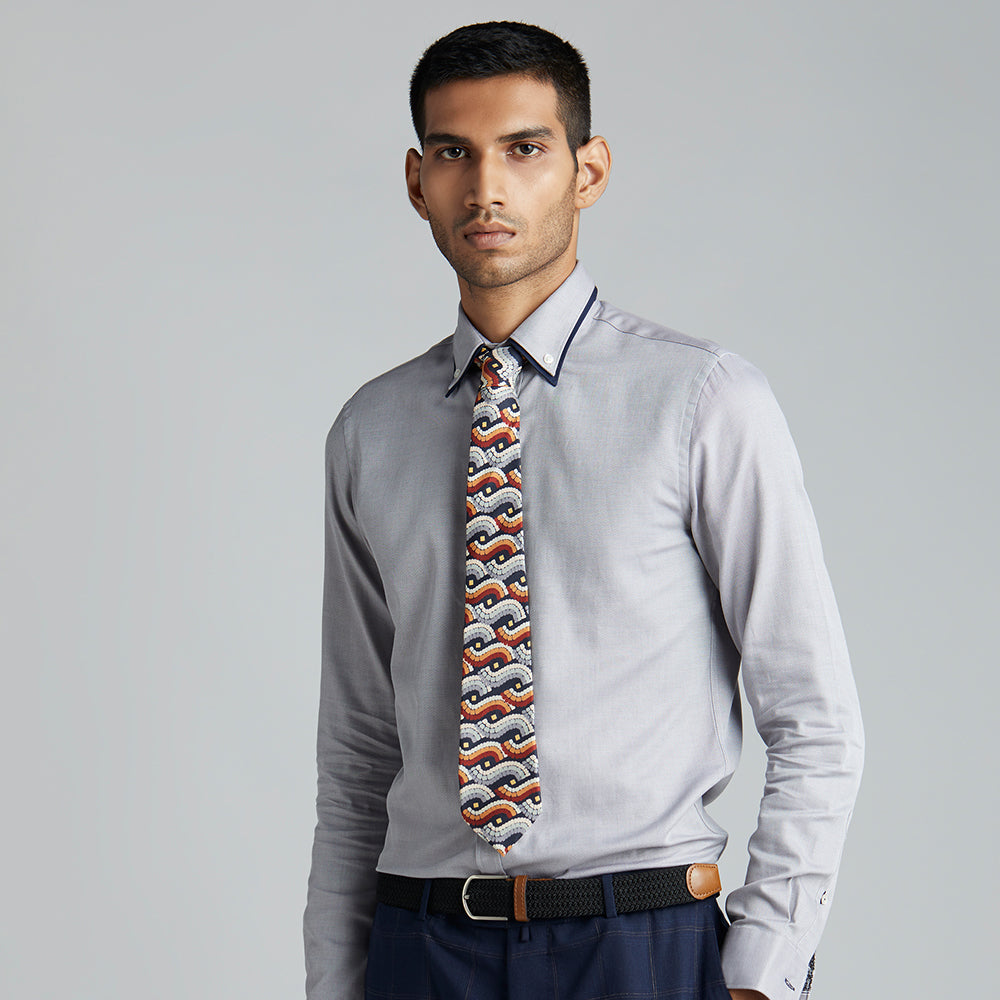 A high contrast neutral tie, with black, white, grey and tan forming a striking geometric print.