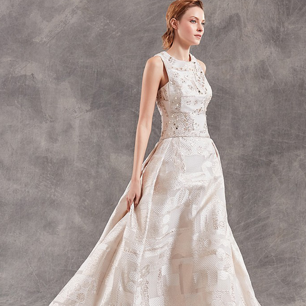Ballgown in organza cloque with geometric pattern and asymmetric hand embroidered bodice.