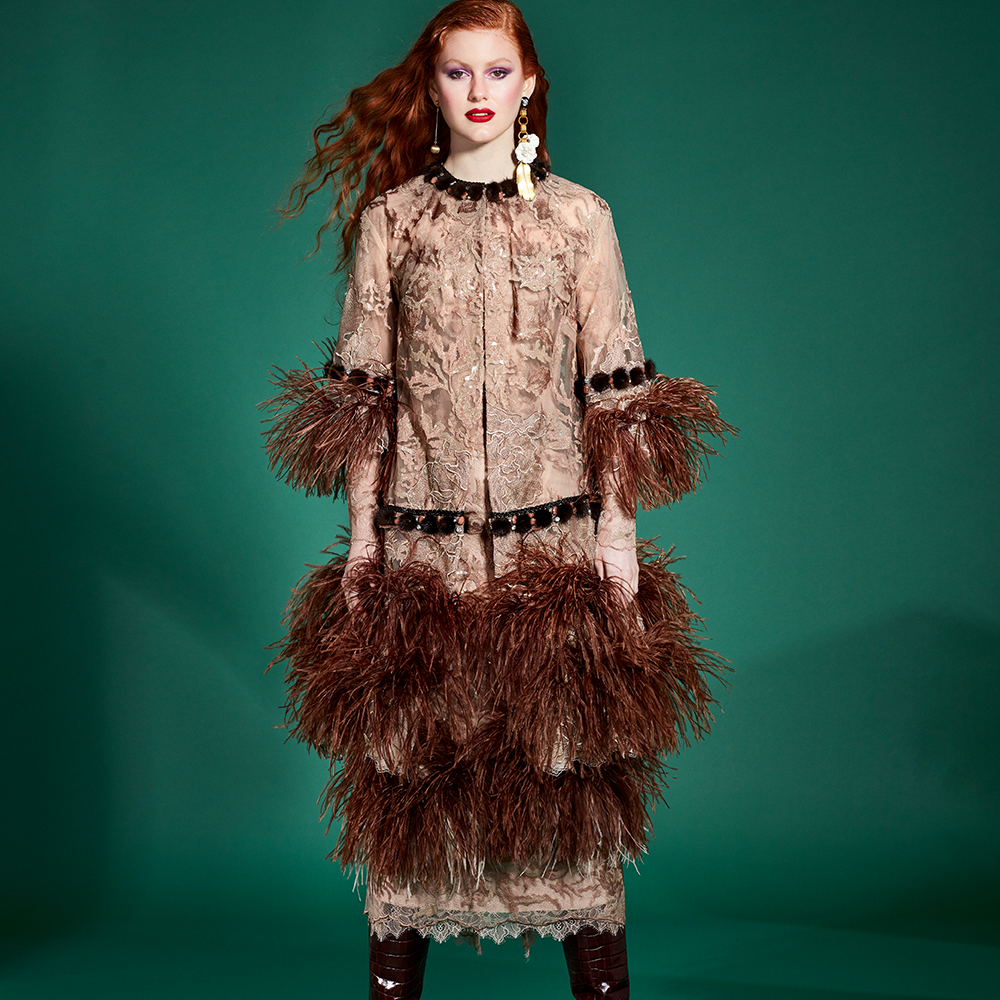 Strips of mink tassels and rhinestones at the neck, sleeves and waist finish the coat.