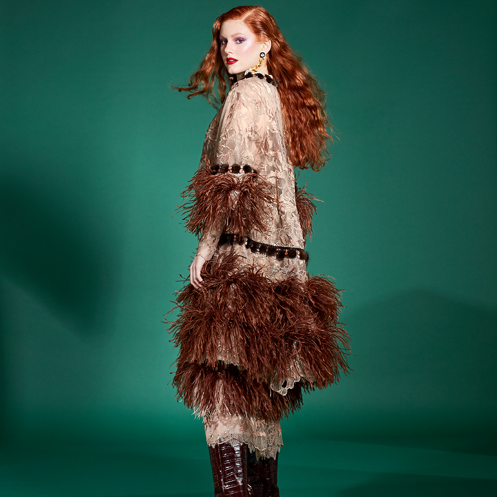 Strips of mink tassels and rhinestones at the neck, sleeves and waist finish the coat.