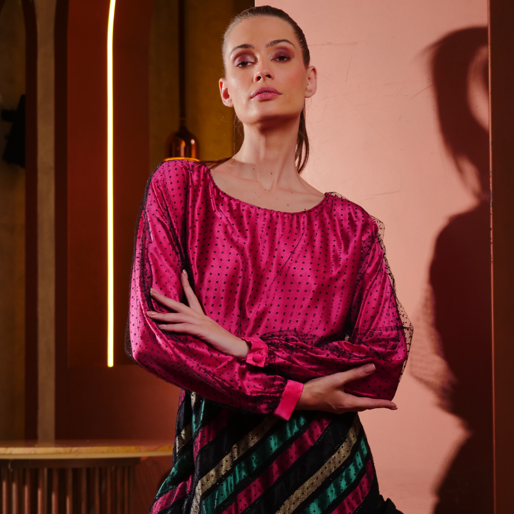 Fuchsia satin long dress paired with a striped skirt, wrapped elegantly in black dotted tulle.