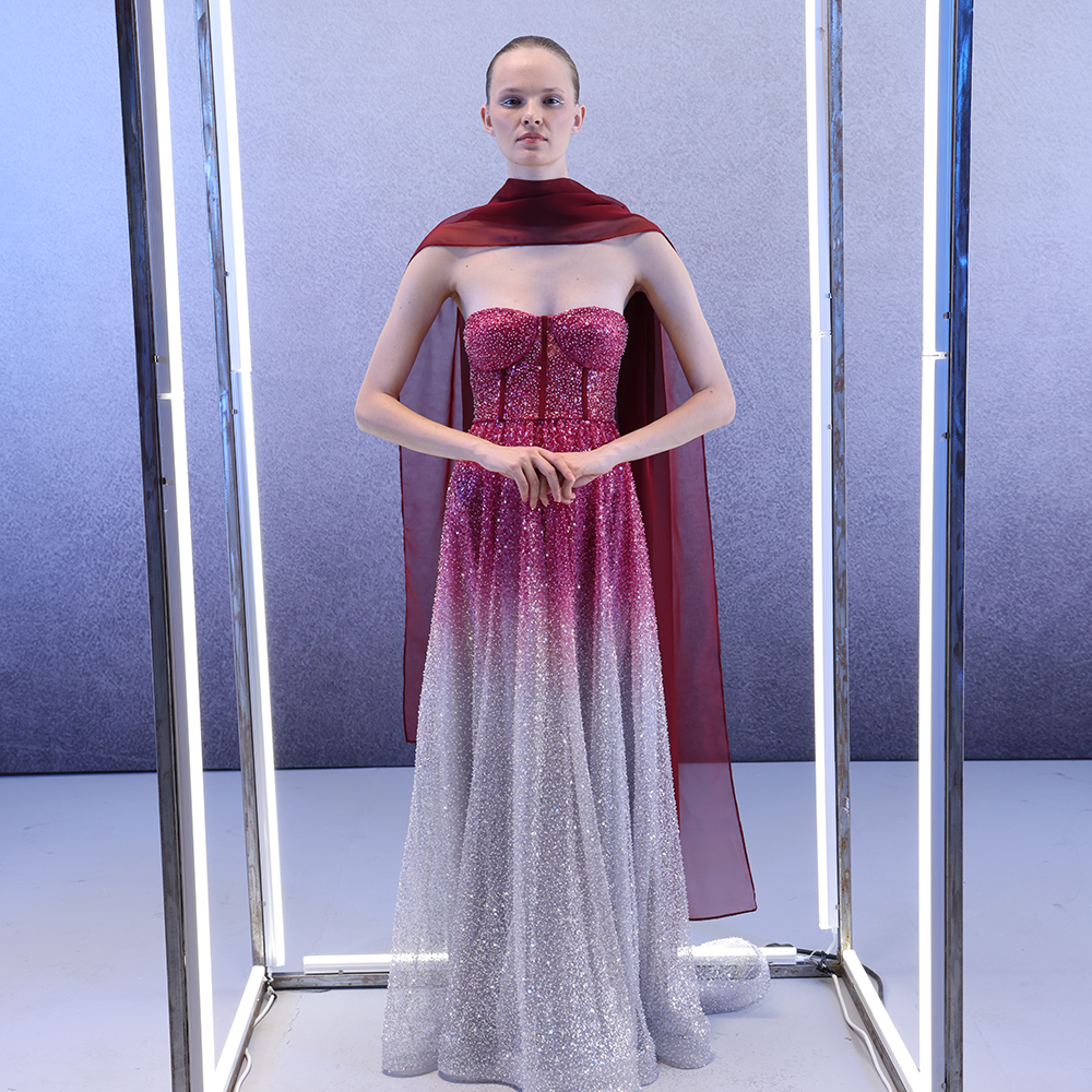 A fully embellished burgundy-to-silver corset gown.