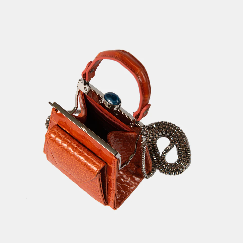 This playful mini bag fuses classic craftsmanship with creative kitsch. Quirky, classy and quintessentially cool.