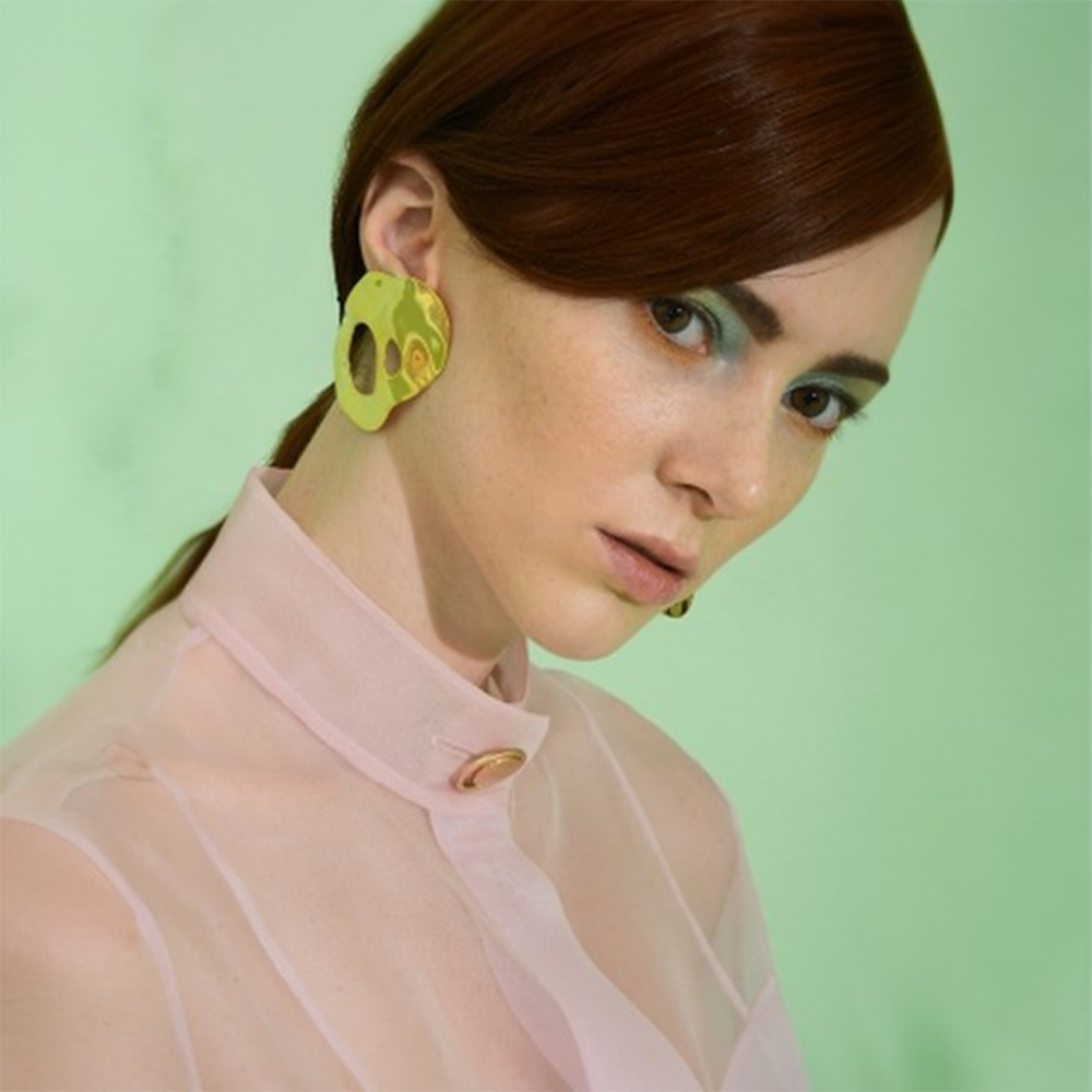 Statement earrings with a reflective surface.