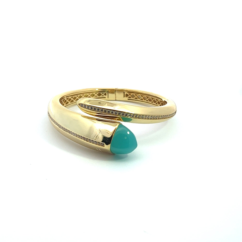 Elegant yellow gold plated cuff bracelet with a colored pyramidal crystal and sparkling pavé cubic zirconia accents. Perfect for luxe everyday styling. Shop premium jewelry online.