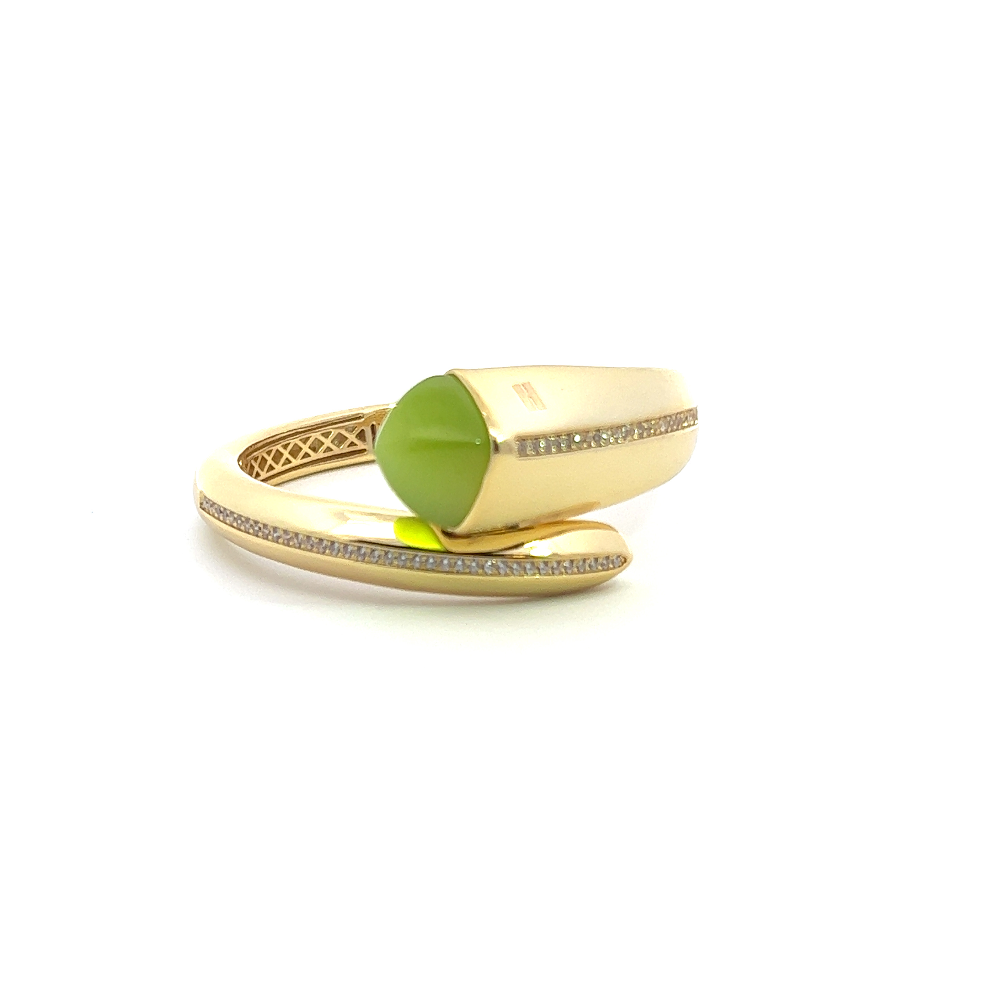 Elegant yellow gold plated cuff bracelet with a colored pyramidal crystal and sparkling pavé cubic zirconia accents. Perfect for luxe everyday styling. Shop premium jewelry online.
