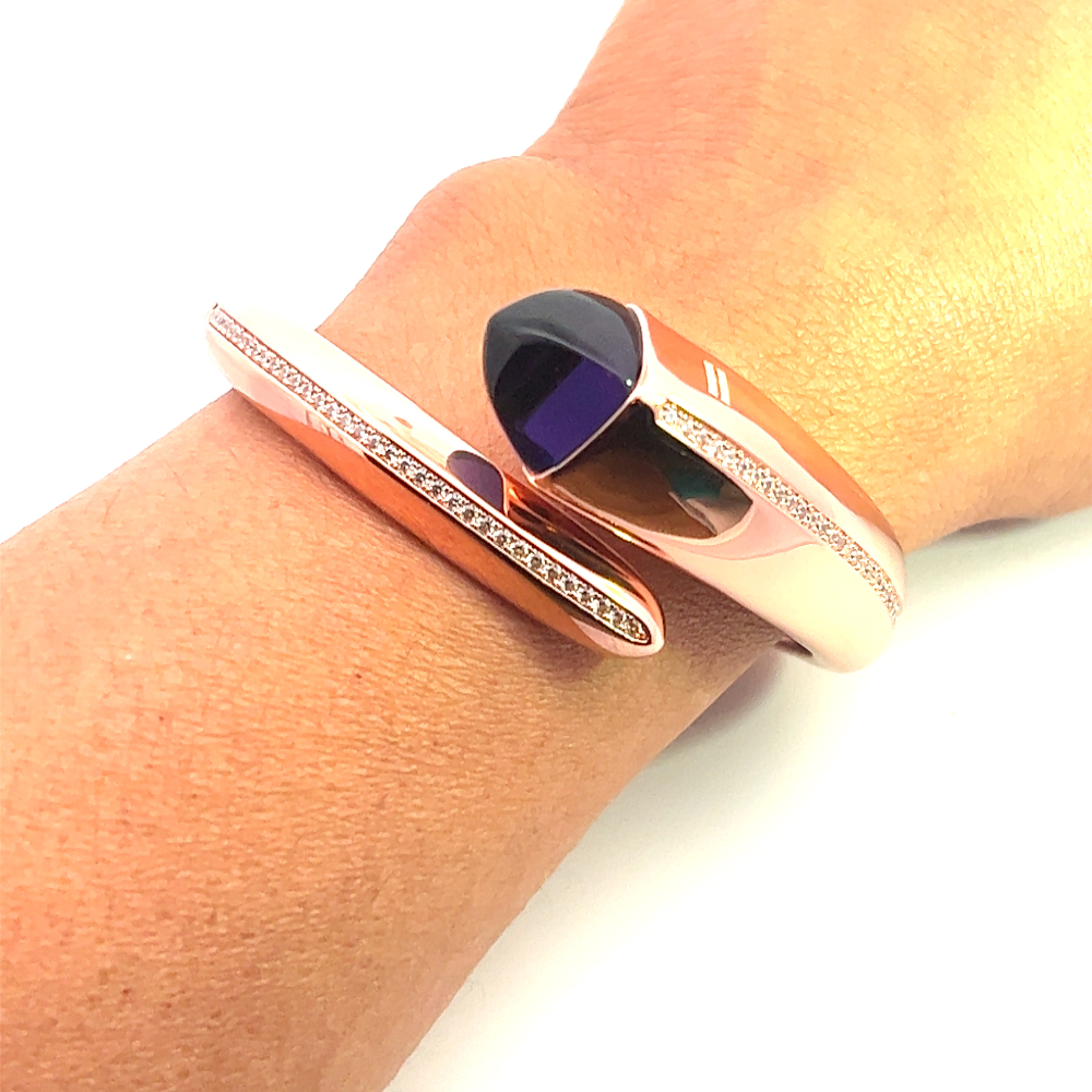 Elegant rose gold plated cuff bracelet with a colored pyramidal crystal and sparkling pavé cubic zirconia accents. Shop premium jewelry online.