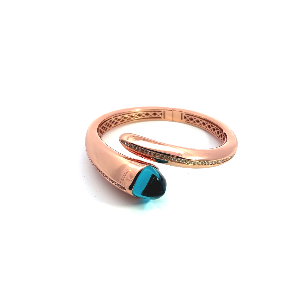 Elegant rose gold plated cuff bracelet with a colored pyramidal crystal and sparkling pavé cubic zirconia accents. Shop premium jewelry online.