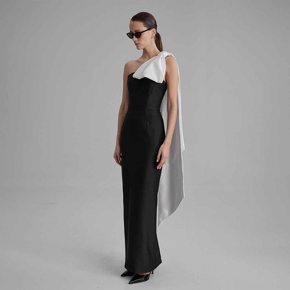 Explore our curation of timeless designer dresses with Gigi black strapless dress with a white cape bow that showcases an elegant silhouette. Shop now!