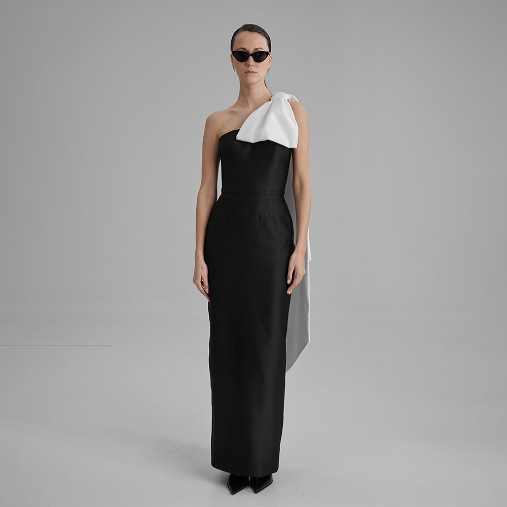 Explore our curation of timeless designer dresses with Gigi black strapless dress with a white cape bow that showcases an elegant silhouette. Shop now!