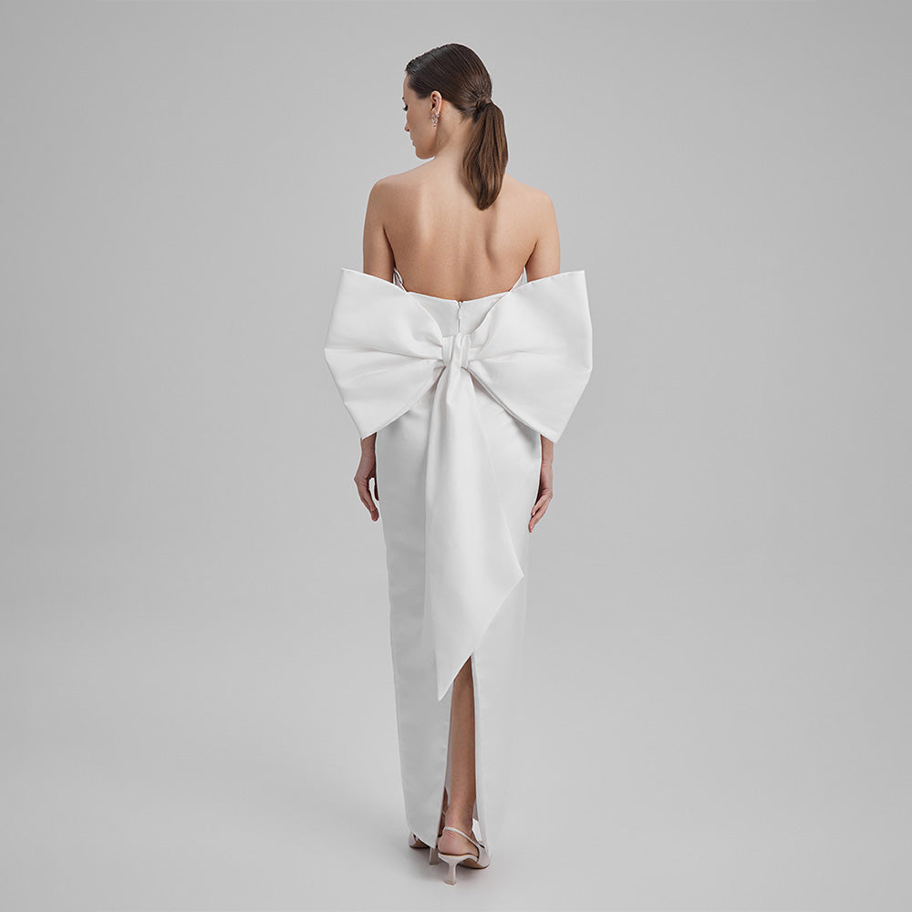 Explore our curation of timeless designer gowns with white strapless dress with a big bow in the back that showcases an elegant silhouette. Shop now!