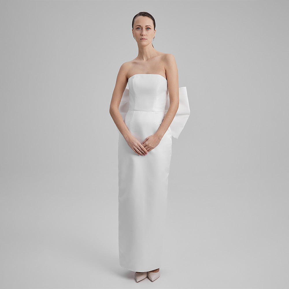 Explore our curation of timeless designer gowns with white strapless dress with a big bow in the back that showcases an elegant silhouette. Shop now!