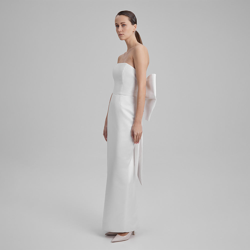 Explore our curation of timeless designer gowns with white strapless dress with a big bow in the back that showcases an elegant silhouette. Shop now!