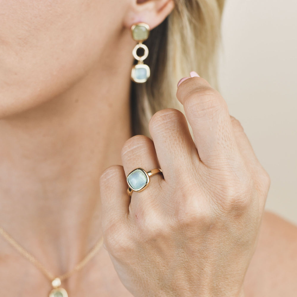Shop online premium gold plated dangle earrings with green and aquamarine crystals separated by elegant circular module detailing.