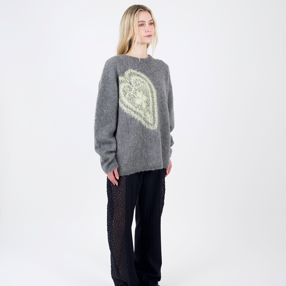 An oversized, warm and cosy mohair knit with a woven graphic heart design inspired by a vintage crochet doily.