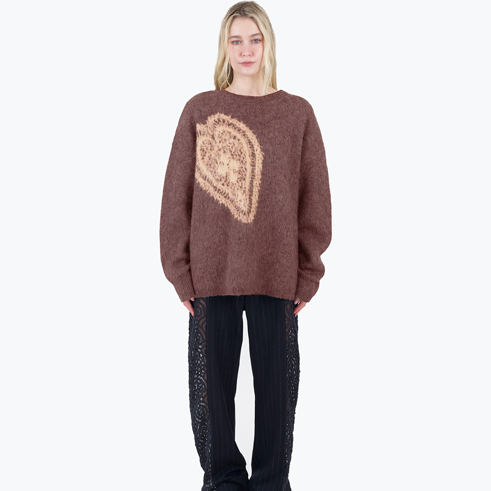 An oversized, warm and cosy mohair knit with a woven graphic heart design inspired by a vintage crochet doily.