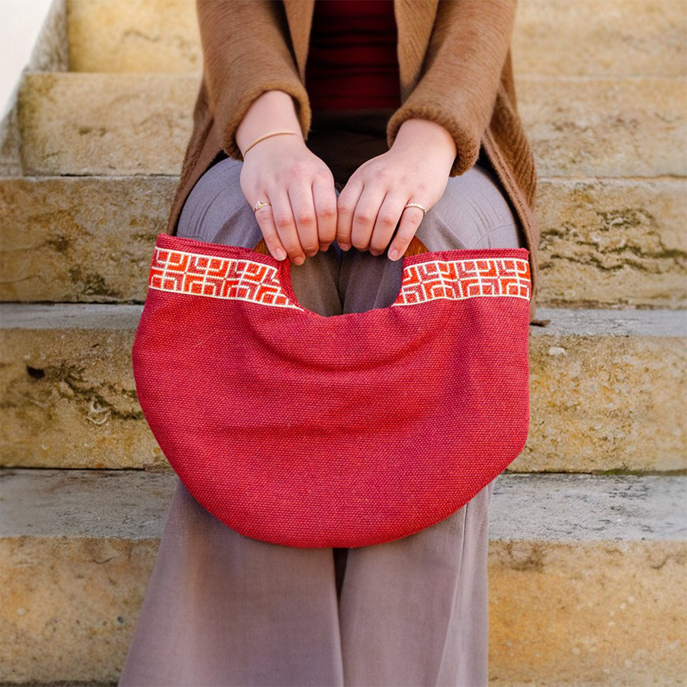 The Half Moon Clutch in Red is an innovative collaboration between our Darzah artisans and talented local carpenters. 
