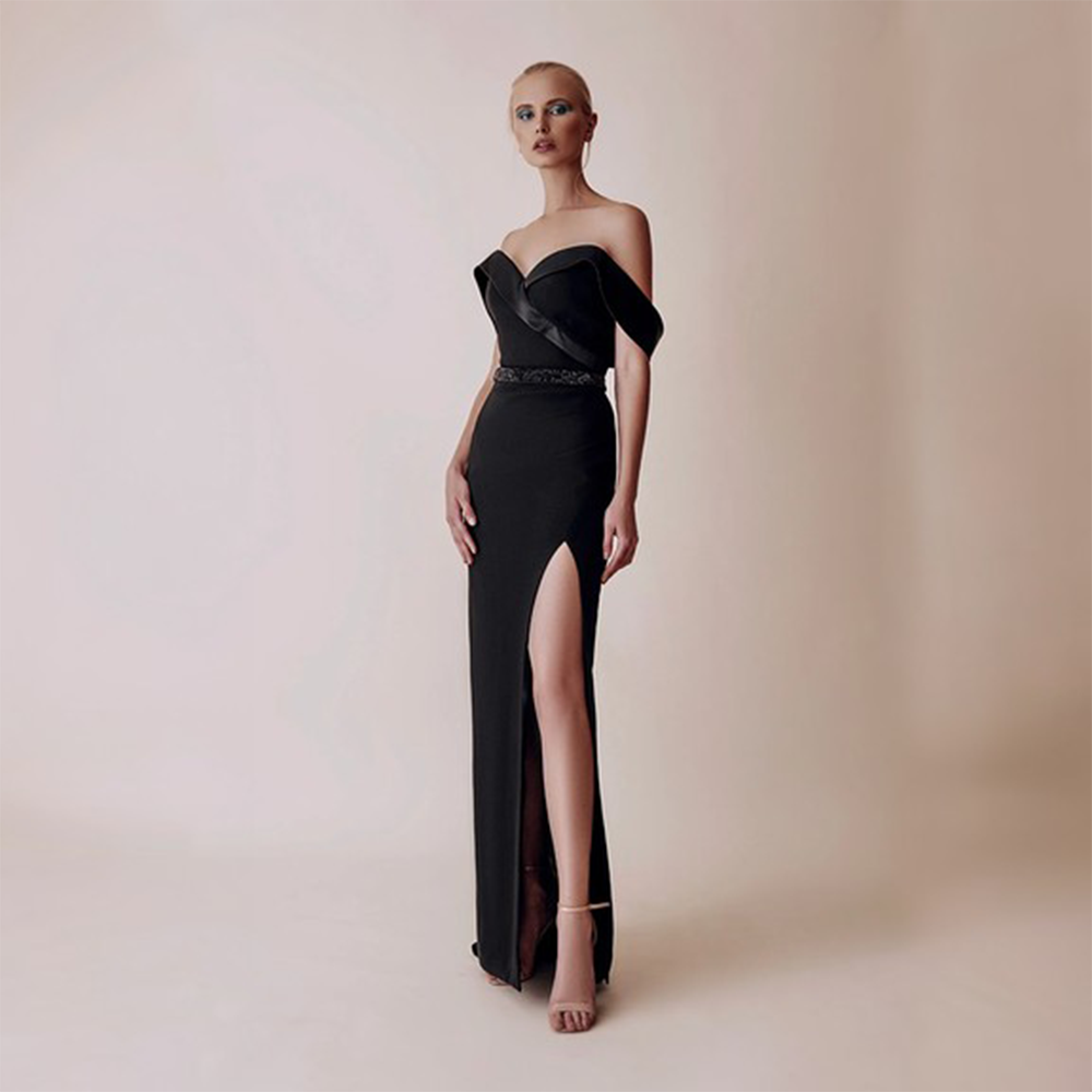Off shoulder dropping sleeves side slit full length dress with belt attached to accentuate the waist.
