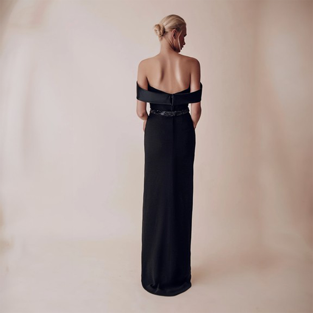 Off shoulder dropping sleeves side slit full length dress with belt attached to accentuate the waist.