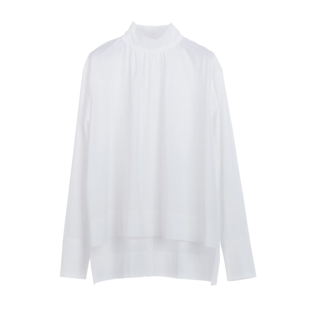 Discover the Ila Blouse at The Luxe Maison, featuring a wide-cut silhouette, stand-up collar, concealed back fastenings, and an asymmetric waistband for versatile styling.