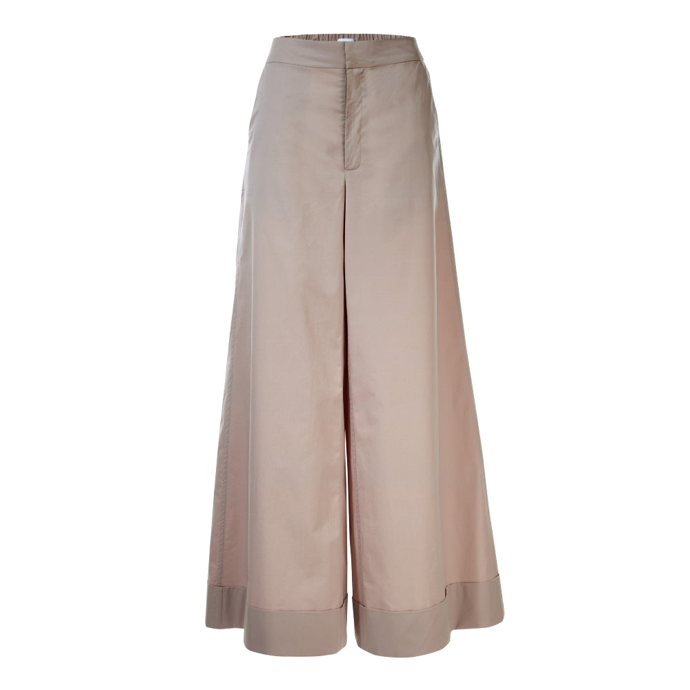 Discover the Ila Trousers at The Luxe Maison, featuring a high-waisted palazzo fit, flared legs, wide turn-ups, an elasticated back waistband, and practical pockets.