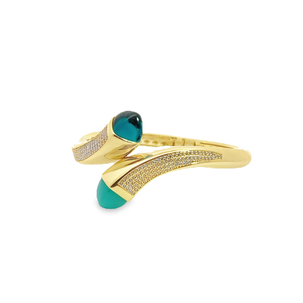 Elegant yellow gold plated wrap cuff bracelet with blue chalcedony crystals and pavé cubic zirconia accents. A luxe statement piece for every occasion. Shop premium jewelry online.