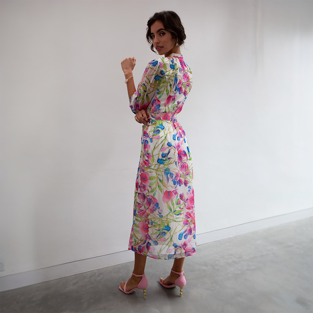 This is a maxi-length dress featuring a delicate floral print with shades of pink, green and blue. 