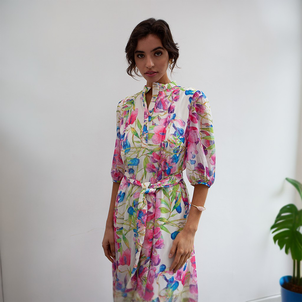 This is a maxi-length dress featuring a delicate floral print with shades of pink, green and blue. 