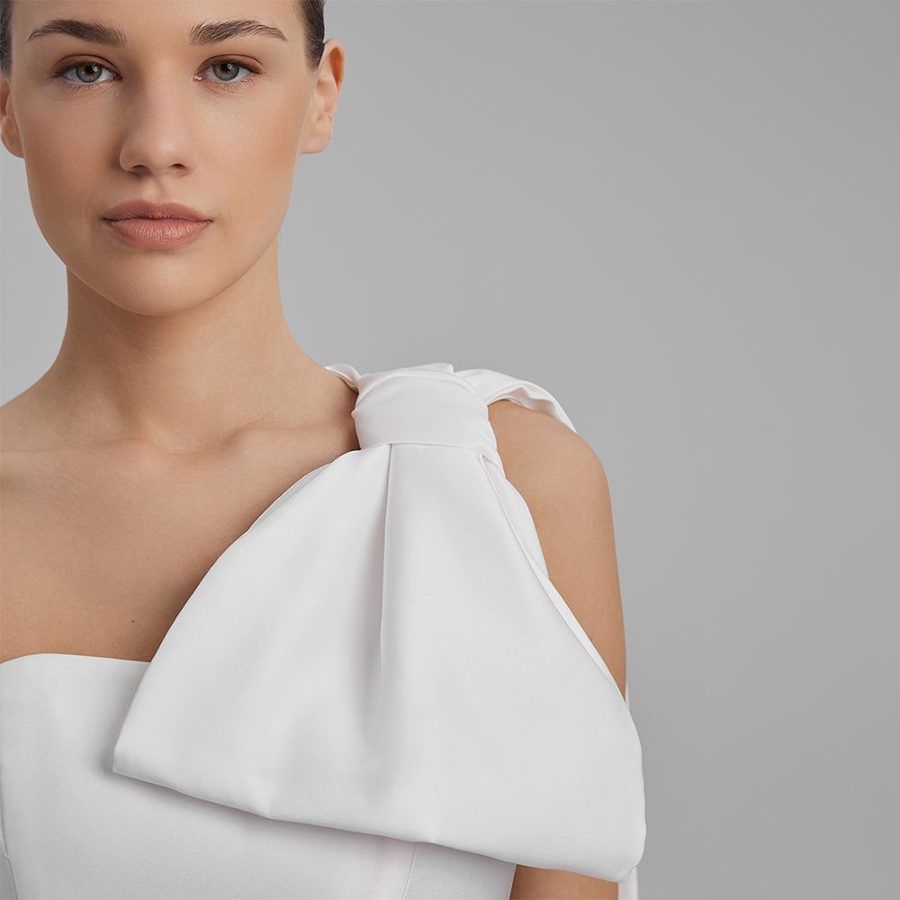 Shop our white mini dress crafted from Mikado with strapless corset and removable cape bow. Explore our range of designer dresses for women. Shop now!