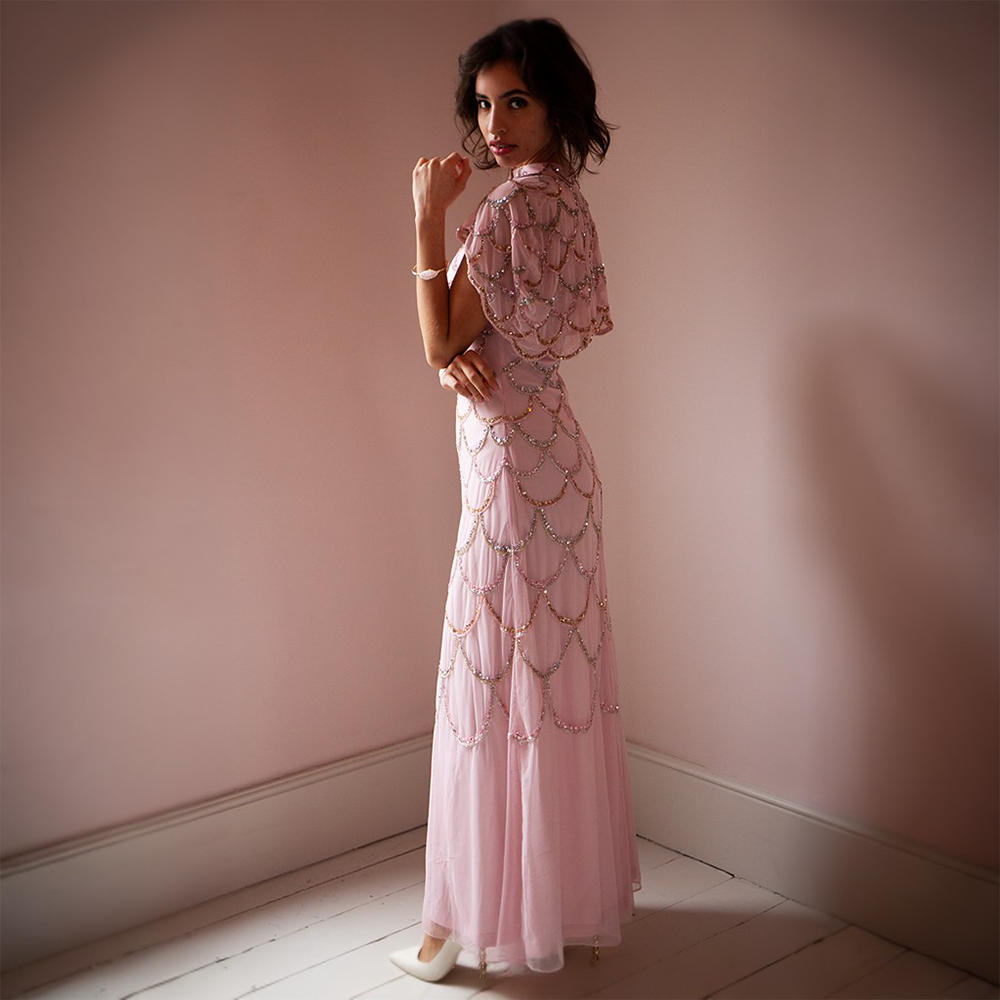 This glamorous light pink floor-length gown features gold and silver sequins 