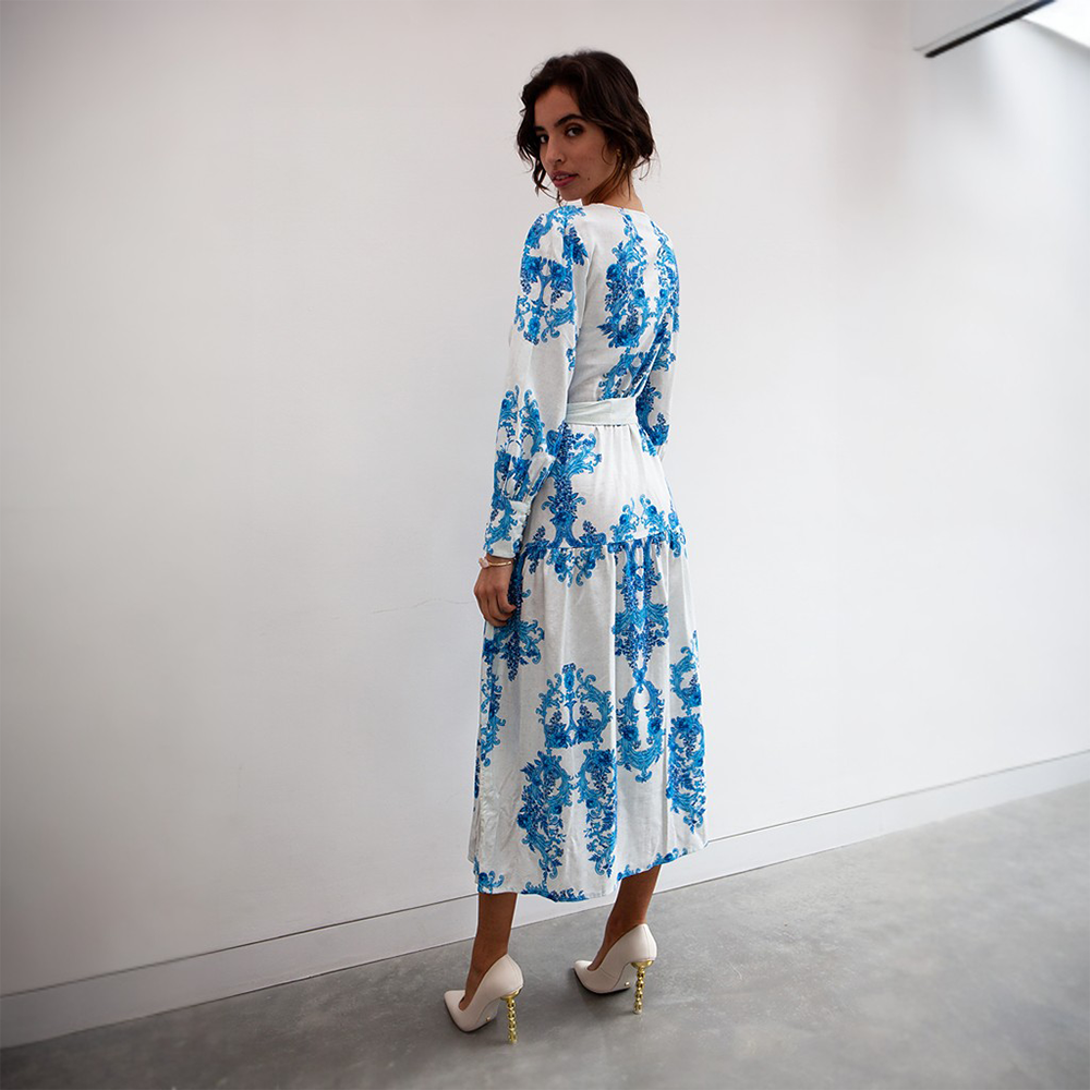 The blue floral pattern pops against the crisp and clean white background of this midi length dress