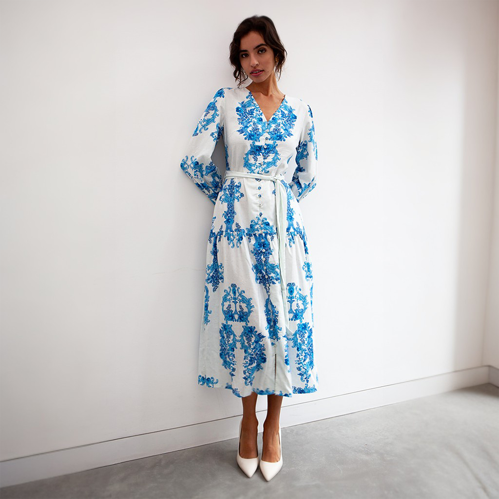 The blue floral pattern pops against the crisp and clean white background of this midi length dress